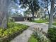 Charming home with stone accents, mature trees, and a well-manicured lawn at 2102 Doefield Ct, Valrico, FL 33596