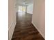 Hallway with wood floors that opens to a room with sliding glass doors at 2102 Doefield Ct, Valrico, FL 33596