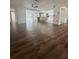 Open-concept living room with wood floors and a view of the kitchen at 2102 Doefield Ct, Valrico, FL 33596