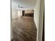 Open living space boasting hardwood floors, a ceiling fan, and a stone fireplace at 2102 Doefield Ct, Valrico, FL 33596