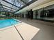 The screened-in pool is seamlessly connected to a covered outdoor area featuring a stylish bar and expansive windows at 2102 Doefield Ct, Valrico, FL 33596