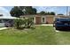 Well-maintained lawn and landscaping enhance the curb appeal of this home at 2120 W Virginia Ave, Tampa, FL 33607