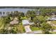 Stunning aerial view of a lakefront home, featuring a spacious yard, lush landscaping, and a sparkling pool, all with lake access at 21906 Shamu Dr, Land O Lakes, FL 34639