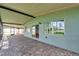 View of enclosed back porch featuring brick pavers and view of lake at 21906 Shamu Dr, Land O Lakes, FL 34639