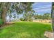 Expansive backyard with lush lawn, mature trees, and views of the lake at 21906 Shamu Dr, Land O Lakes, FL 34639