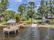 Aerial view showcasing the backyard's waterfront gazebo, boat ramp, and well-manicured lawn at 21906 Shamu Dr, Land O Lakes, FL 34639