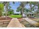Expansive backyard with a boat dock, boat parking, a covered picnic area, and lush, mature landscaping at 21906 Shamu Dr, Land O Lakes, FL 34639