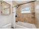 Bathroom with a tiled shower and tub, a rain shower head, and a charming decorative mirror at 21906 Shamu Dr, Land O Lakes, FL 34639