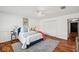 Bright bedroom features hardwood floors, a plush rug, and a comfortable bed with tasteful decor at 21906 Shamu Dr, Land O Lakes, FL 34639