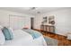 Bright bedroom features stylish decor, wood flooring, and spacious closet space at 21906 Shamu Dr, Land O Lakes, FL 34639