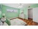 Mint bedroom featuring a ceiling fan, window, dresser, and wood-look flooring at 21906 Shamu Dr, Land O Lakes, FL 34639