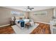 Well-lit bedroom with ceiling fan, hardwood floors, and ample natural light at 21906 Shamu Dr, Land O Lakes, FL 34639