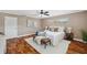 Bright bedroom with hardwood floors, area rug, and comfortable bench at 21906 Shamu Dr, Land O Lakes, FL 34639