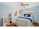 Charming bedroom with hardwood floors, beach decor, and natural light at 21906 Shamu Dr, Land O Lakes, FL 34639