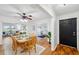 Bright dining room featuring a wooden table set for a meal, hardwood floors, and a view of the lake at 21906 Shamu Dr, Land O Lakes, FL 34639