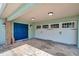 Attached garage and entry featuring a blue double door and neutral trim at 21906 Shamu Dr, Land O Lakes, FL 34639