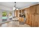 Bright kitchen area with dining nook overlooks pool through French doors at 21906 Shamu Dr, Land O Lakes, FL 34639