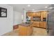 Bright kitchen with central island, light wood cabinets and tile flooring at 21906 Shamu Dr, Land O Lakes, FL 34639