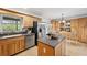 Kitchen featuring wood cabinets, stainless steel appliances, and an island at 21906 Shamu Dr, Land O Lakes, FL 34639