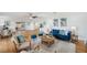 Cozy living room featuring wood floors, soft blue accents, and modern decor at 21906 Shamu Dr, Land O Lakes, FL 34639