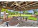 Covered picnic area featuring a built-in bar top, ceiling fans, decorative lighting, and paver flooring at 21906 Shamu Dr, Land O Lakes, FL 34639