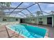 Screened-in pool with brick surround, and a view of the backyard at 21906 Shamu Dr, Land O Lakes, FL 34639