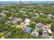 Aerial view of a neighborhood surrounded by lush trees with city and water views at 2604 W Jetton Ave, Tampa, FL 33629