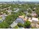 Aerial view of a neighborhood surrounded by lush trees with city skyline views at 2604 W Jetton Ave, Tampa, FL 33629