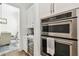Bar area featuring a wine fridge, marble countertop, and white cabinets at 2604 W Jetton Ave, Tampa, FL 33629