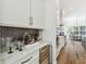 Bar area featuring a wine fridge, marble countertop, and gray tile backsplash at 2604 W Jetton Ave, Tampa, FL 33629