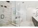 Bright bathroom featuring a glass shower, soaking tub, marble accents and double vanity at 2604 W Jetton Ave, Tampa, FL 33629