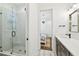 Bathroom with a glass shower, modern fixtures, and doorway to bedroom at 2604 W Jetton Ave, Tampa, FL 33629