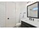Bathroom with shower/tub combo and designer black and white patterned floors at 2604 W Jetton Ave, Tampa, FL 33629