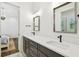 Bathroom with a double sink vanity, modern fixtures, and large mirrors at 2604 W Jetton Ave, Tampa, FL 33629