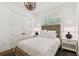 Bedroom with a full-size bed, wood floors, and white color scheme at 2604 W Jetton Ave, Tampa, FL 33629