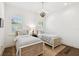 Bedroom with natural wood floors, twin beds, and shuttered windows at 2604 W Jetton Ave, Tampa, FL 33629