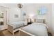 Bright bedroom with two twin beds, wood floors, and a decorative chandelier at 2604 W Jetton Ave, Tampa, FL 33629