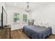 Well-lit bedroom with natural wood floors and charming chandelier at 2604 W Jetton Ave, Tampa, FL 33629
