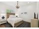 Bedroom with a full-size bed, wood floors, and a decorative chandelier at 2604 W Jetton Ave, Tampa, FL 33629