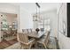 Dining room featuring a rectangular table, gray upholstered chairs, and modern light fixture at 2604 W Jetton Ave, Tampa, FL 33629