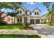 Stunning two-story modern farmhouse exterior with a manicured lawn and a two-car garage at 2604 W Jetton Ave, Tampa, FL 33629