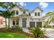 Stunning two-story modern farmhouse exterior with a manicured lawn and a two-car garage at 2604 W Jetton Ave, Tampa, FL 33629