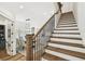 Grand foyer featuring a wood staircase, hardwood floors, and views into the dining room at 2604 W Jetton Ave, Tampa, FL 33629