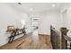 Upstairs hallway with hardwood floors and a view into the primary bedroom at 2604 W Jetton Ave, Tampa, FL 33629