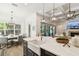Kitchen island with white countertop, apron sink, and adjacent dining area at 2604 W Jetton Ave, Tampa, FL 33629