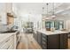 Bright kitchen featuring a large island, stainless appliances, and wood flooring at 2604 W Jetton Ave, Tampa, FL 33629