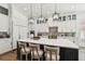 Bright, modern kitchen features a large island with seating and pendant lighting at 2604 W Jetton Ave, Tampa, FL 33629