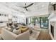 Open concept living room with coffered ceiling, fireplace, and access to a pool at 2604 W Jetton Ave, Tampa, FL 33629