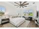 Bright bedroom featuring a tray ceiling, hardwood floors, and plantation shutters at 2604 W Jetton Ave, Tampa, FL 33629