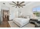 Bright main bedroom with a large ceiling fan, hardwood floors and neutral colors at 2604 W Jetton Ave, Tampa, FL 33629